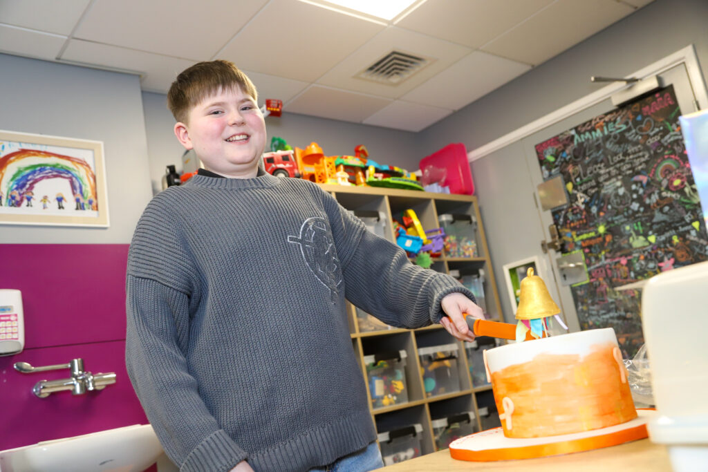 All smiles from Oscar as he cuts celebratory cake