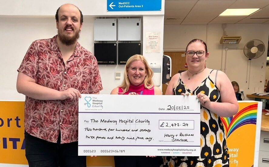 Harry and Rachael Sherlock with Donna Law holding a large cheque