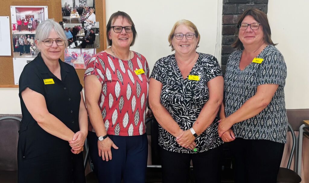 Image shows four women stood side by side in a hall. The women, who work for Medway Maritime Hospital, were all instrumental in setting up the new support group for breast and bowel metastatic cancer patients following patient feedback.
