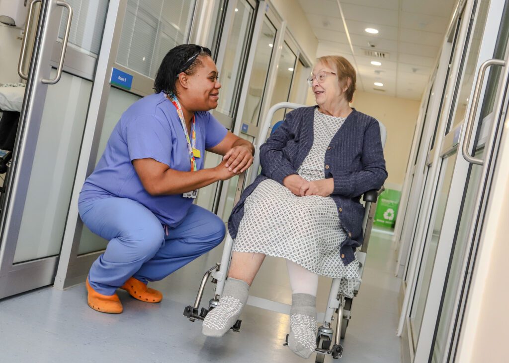 Theatre Assistant Practitioner with a patient in a wheelchair